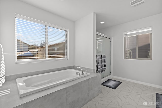 bathroom with shower with separate bathtub