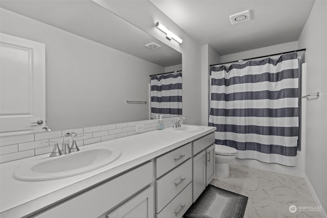 bathroom with vanity, decorative backsplash, a shower with curtain, and toilet