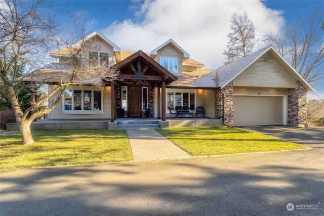 view of front of home featuring a garage, a porch, and a front yard