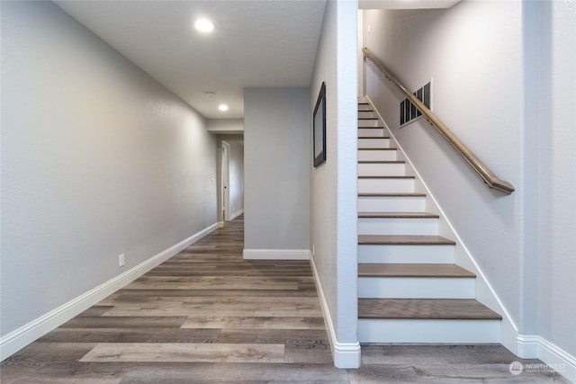 staircase featuring hardwood / wood-style flooring