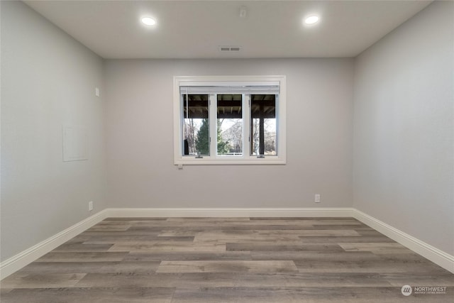 unfurnished room featuring hardwood / wood-style floors