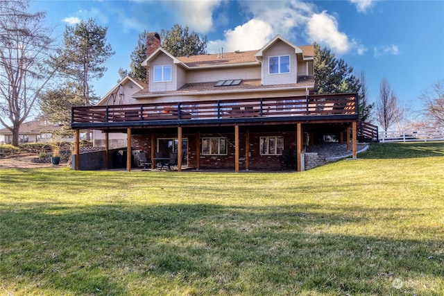 rear view of property featuring a yard and a deck