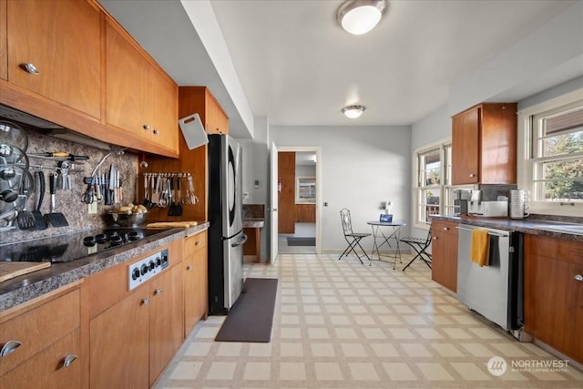 kitchen with tasteful backsplash and appliances with stainless steel finishes