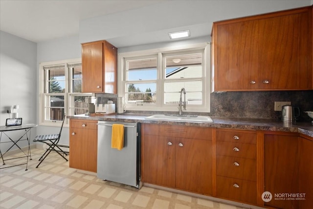 kitchen featuring tasteful backsplash, dishwasher, and sink