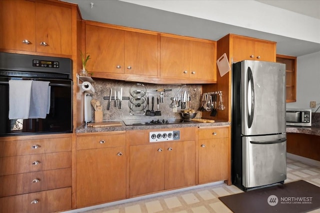 kitchen with backsplash and black appliances