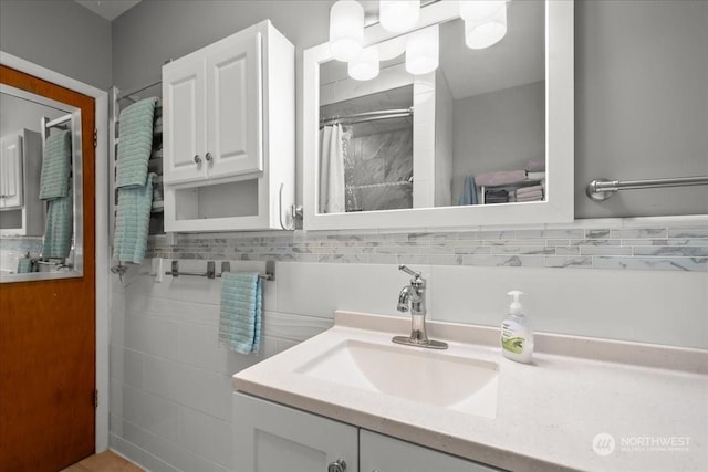 bathroom featuring vanity, tile walls, and walk in shower