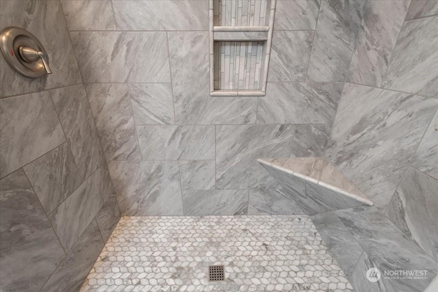 bathroom with tiled shower