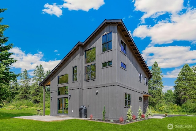 rear view of property featuring a patio and a lawn