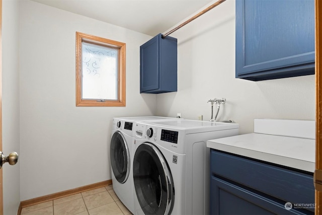 laundry room featuring cabinets, washing machine and dryer, and light tile patterned floors