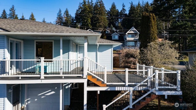 back of property with a garage and covered porch