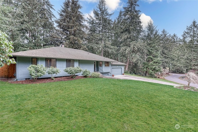 ranch-style home featuring a garage and a front lawn