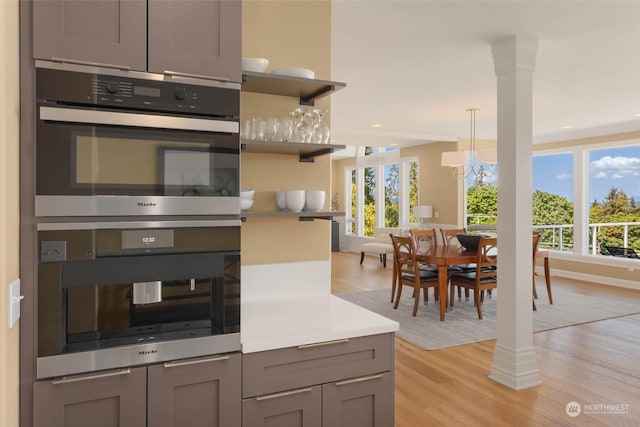 kitchen with a wealth of natural light, double oven, and gray cabinetry