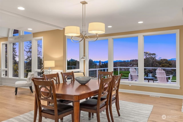 dining room featuring a notable chandelier and light hardwood / wood-style flooring