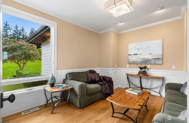 living room featuring ornamental molding and light wood-type flooring