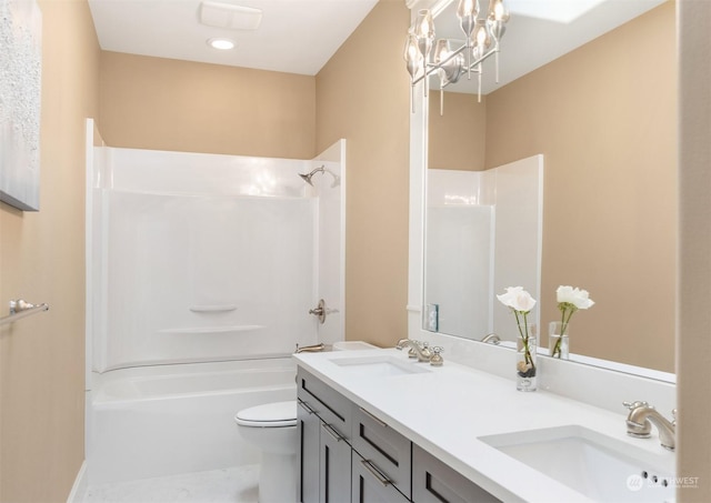 full bathroom featuring a notable chandelier, shower / washtub combination, vanity, and toilet