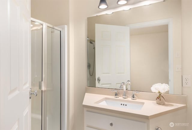 bathroom with vanity and a shower with shower door