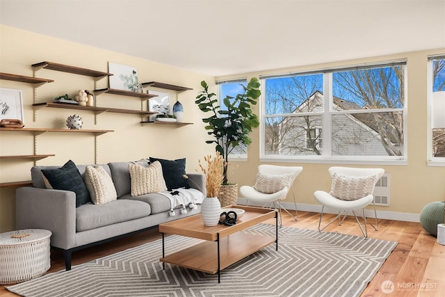 living area featuring baseboards and wood finished floors