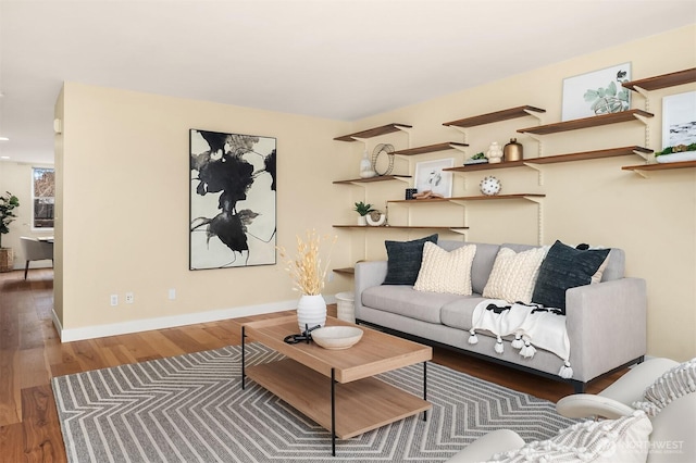 living room with baseboards and wood finished floors