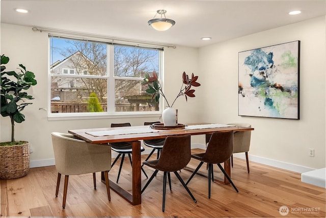 dining space with recessed lighting, wood finished floors, and baseboards