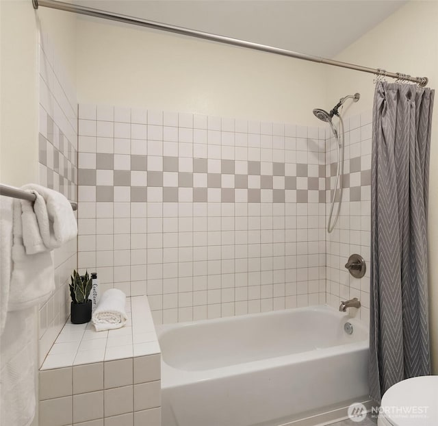 bathroom with shower / bath combination with curtain and toilet