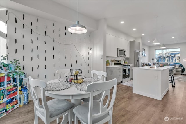 dining room with sink and light hardwood / wood-style floors