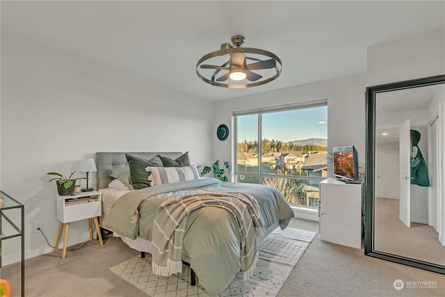 bedroom featuring ceiling fan and light carpet