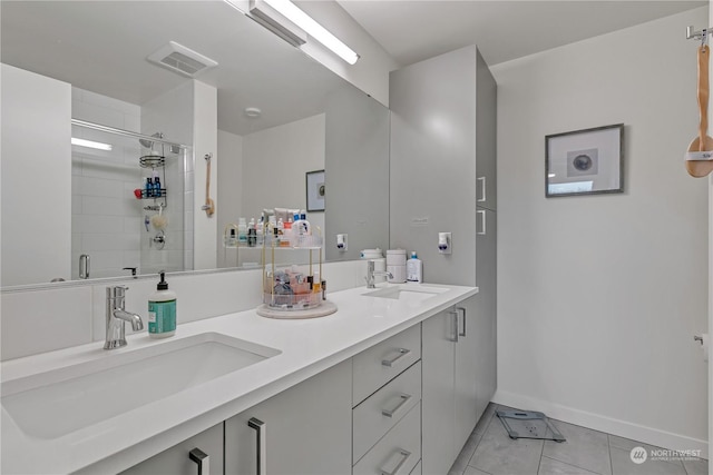 bathroom with walk in shower, vanity, and tile patterned flooring