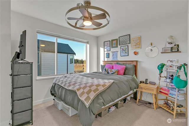 bedroom featuring light colored carpet and ceiling fan