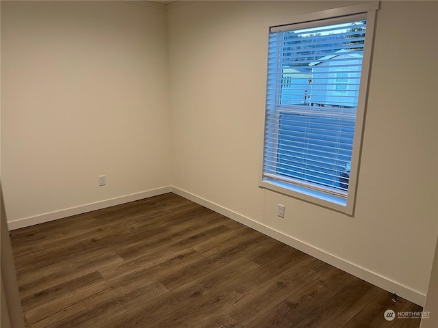 spare room featuring dark wood-type flooring