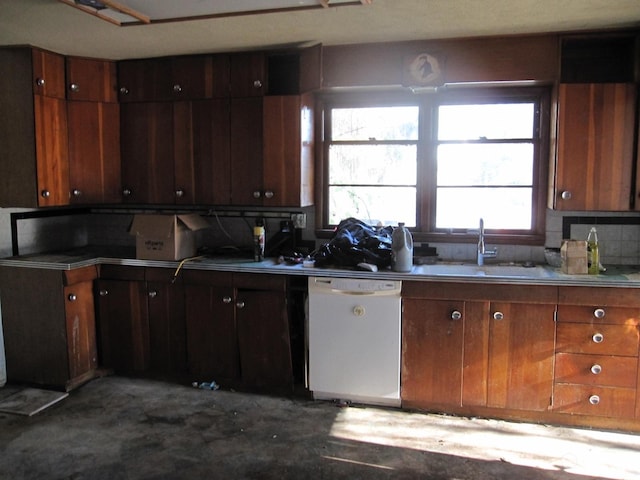 kitchen featuring white dishwasher, sink, and backsplash