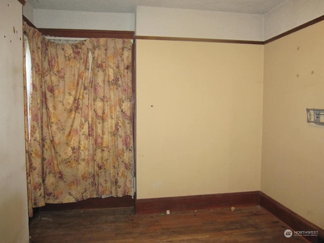 spare room with dark hardwood / wood-style floors