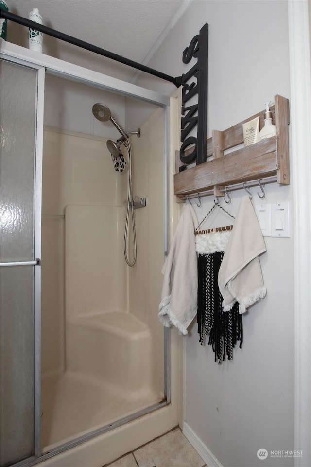 bathroom featuring tile patterned flooring and a shower with shower door