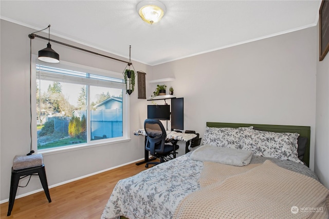 bedroom featuring hardwood / wood-style flooring and crown molding