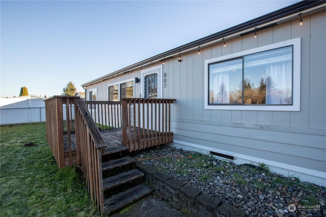 exterior space featuring a wooden deck and a yard