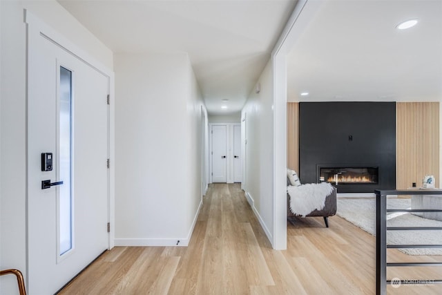 corridor with light hardwood / wood-style floors