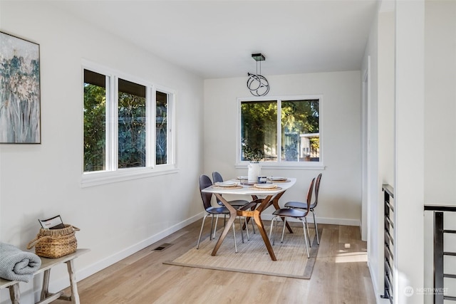 dining area featuring light wood-type flooring