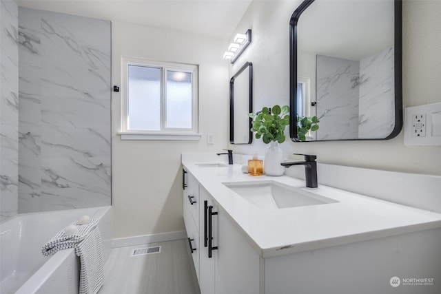 bathroom featuring vanity and a tub to relax in