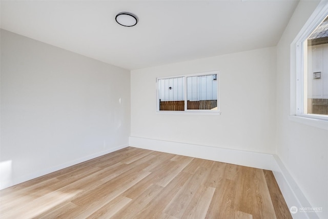 spare room with light hardwood / wood-style flooring