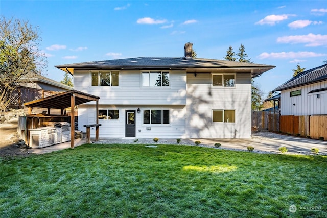 rear view of property featuring a patio and a yard