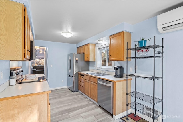 kitchen featuring sink, a wall mounted air conditioner, light wood-type flooring, and appliances with stainless steel finishes