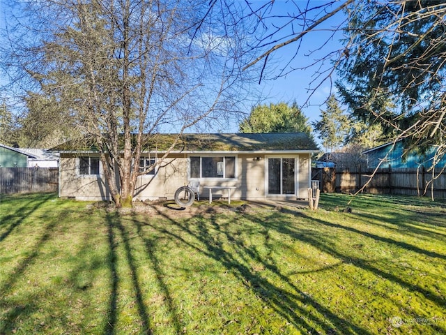 back of house featuring a yard