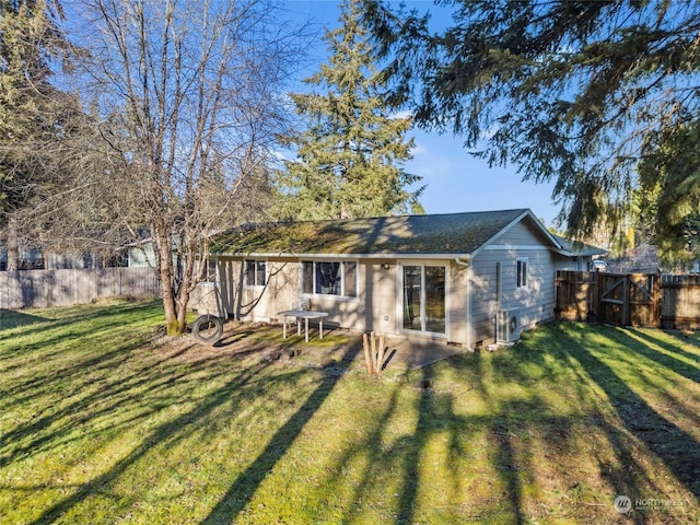 rear view of property featuring a lawn