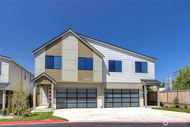 21402 39th Dr SE Unit A, Bothell, WA 98021 - contemporary house featuring a garage, driveway, and stone siding
