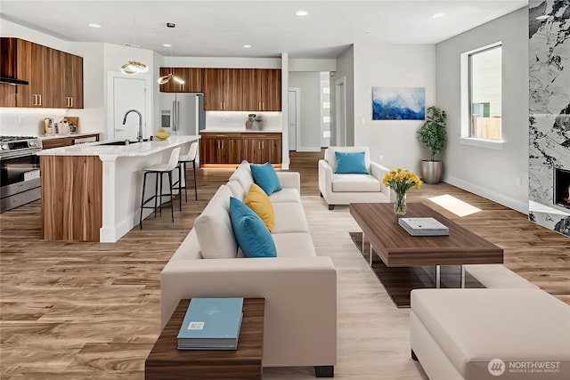 21402 39th Dr SE Unit A, Bothell, WA 98021 - living room featuring light wood-type flooring, baseboards, and recessed lighting