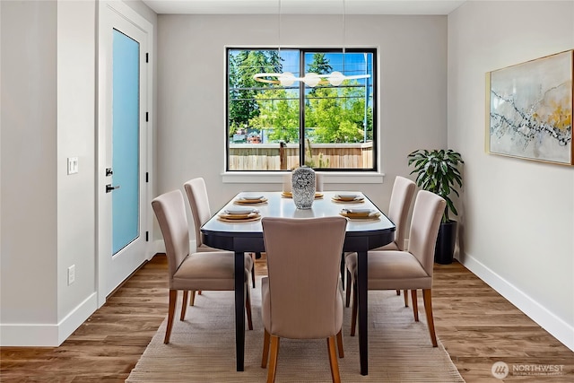 21402 39th Dr SE Unit A, Bothell, WA 98021 - dining area featuring baseboards and wood finished floors