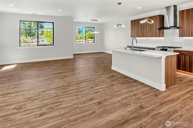 21402 39th Dr SE Unit A, Bothell, WA 98021 - kitchen featuring wall chimney exhaust hood, a sink, light countertops, open floor plan, and baseboards