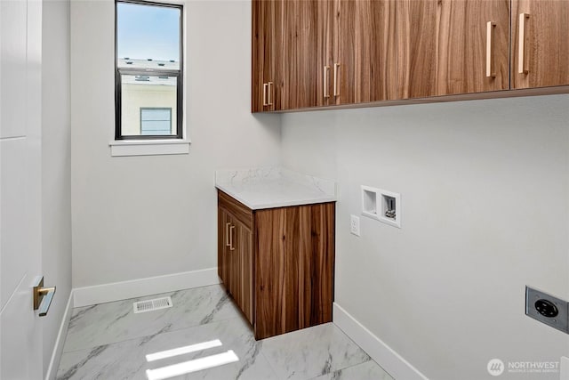 21402 39th Dr SE Unit A, Bothell, WA 98021 - laundry room with hookup for an electric dryer, cabinet space, baseboards, light marble finish floors, and hookup for a washing machine