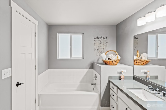 bathroom with vanity and a tub