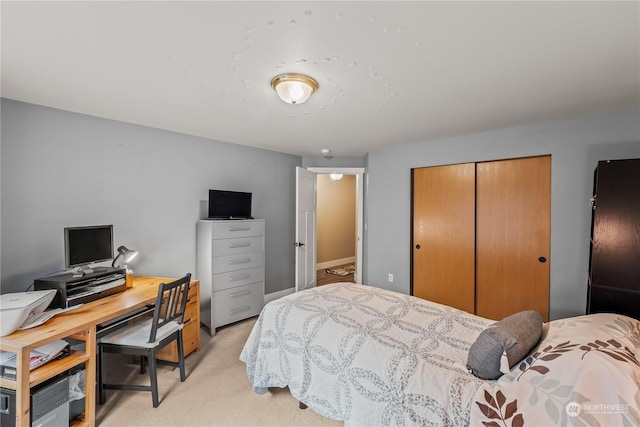 bedroom featuring light carpet and a closet