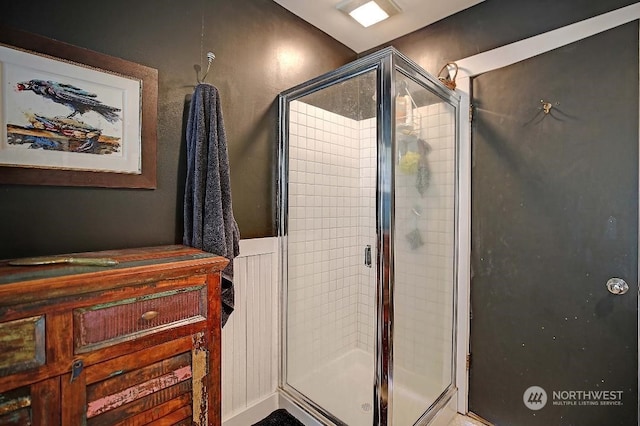 bathroom with a shower with door